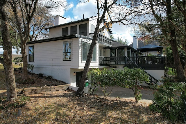 rear view of house featuring a gazebo