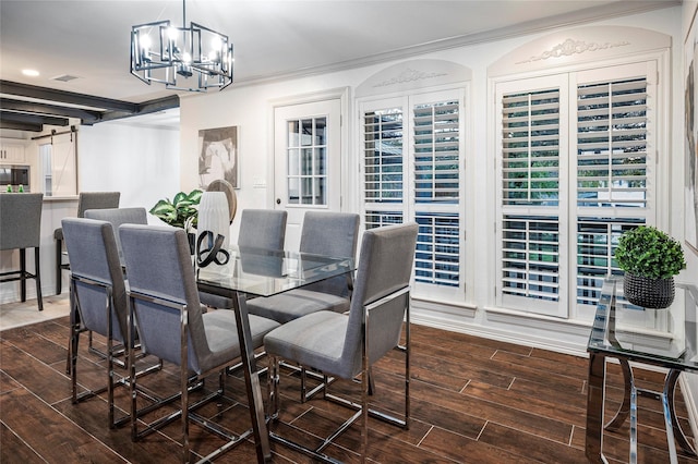 dining area featuring dark hardwood / wood-style floors, a barn door, crown molding, and a notable chandelier