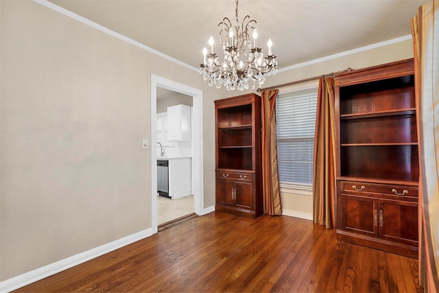 unfurnished dining area featuring dark hardwood / wood-style flooring, ornamental molding, and an inviting chandelier