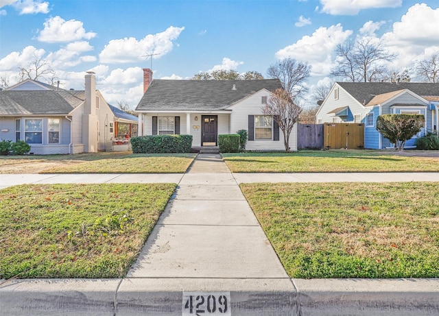 bungalow-style home with a front lawn