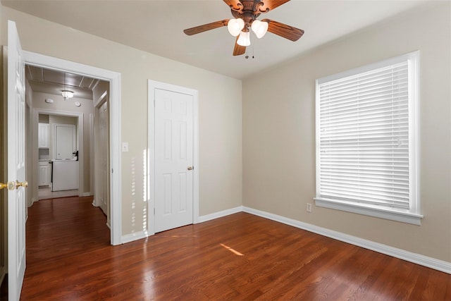 unfurnished bedroom with ceiling fan and dark hardwood / wood-style floors