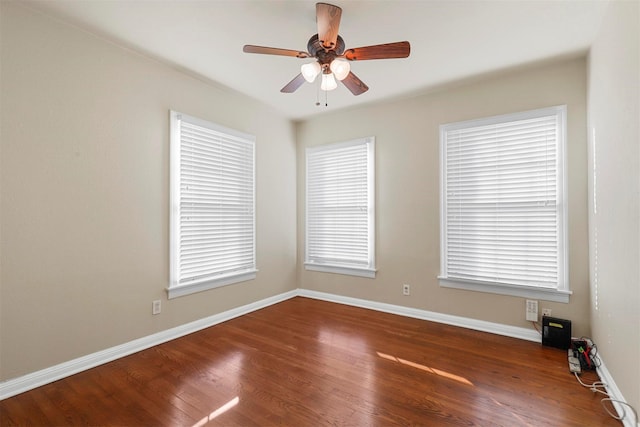 unfurnished room with ceiling fan and dark hardwood / wood-style flooring