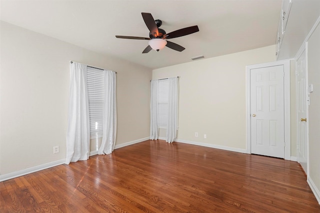 spare room with ceiling fan and dark hardwood / wood-style floors