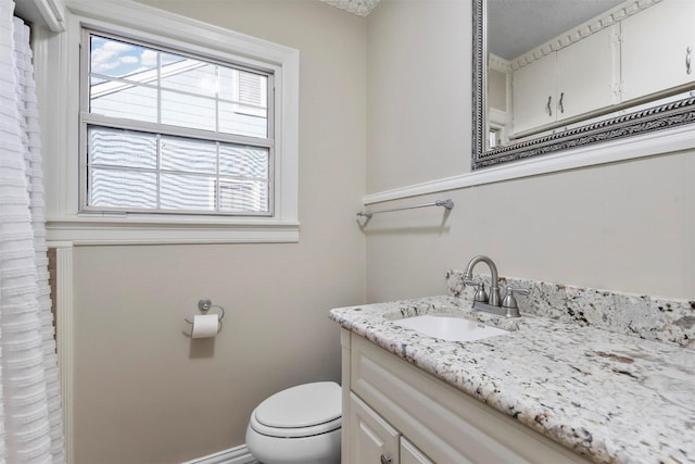 bathroom featuring toilet and vanity