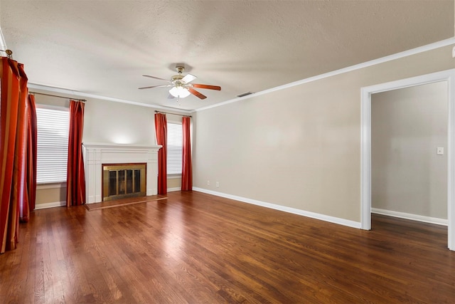 unfurnished living room with a textured ceiling, ceiling fan, dark hardwood / wood-style flooring, and crown molding