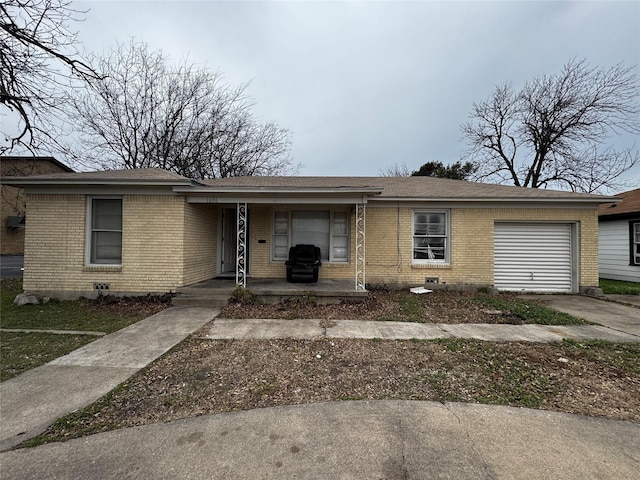 single story home with covered porch and a garage