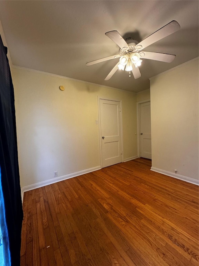 spare room with hardwood / wood-style flooring, ornamental molding, and ceiling fan