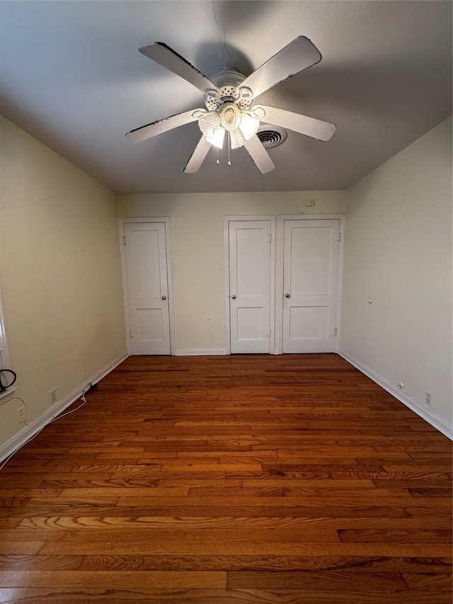 unfurnished bedroom featuring ceiling fan and hardwood / wood-style flooring