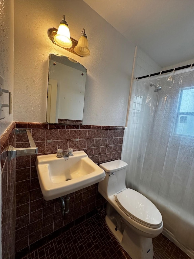 bathroom with tile patterned flooring, sink, tile walls, toilet, and a shower with shower curtain