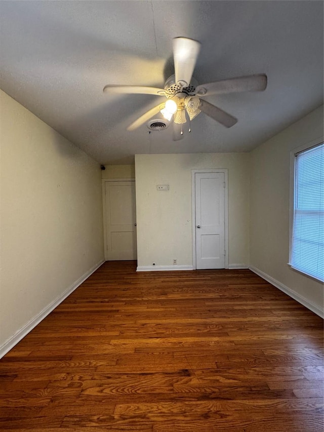 unfurnished room featuring ceiling fan and dark hardwood / wood-style flooring