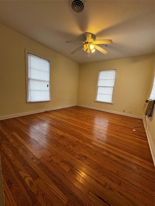 unfurnished room featuring ceiling fan and dark wood-type flooring