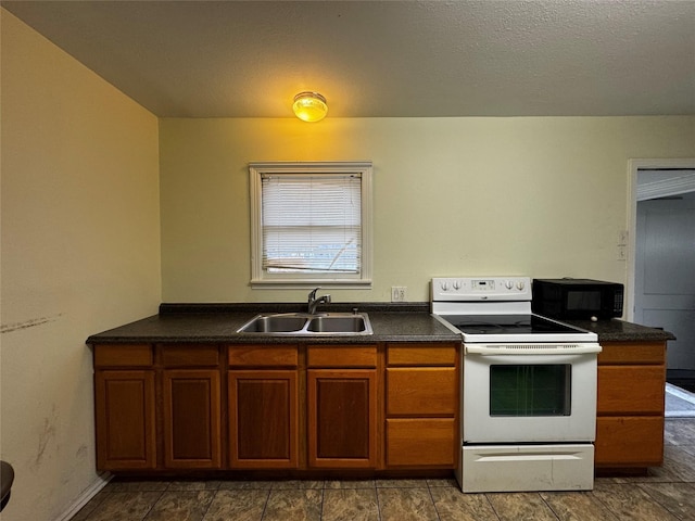 kitchen with a textured ceiling, white electric range oven, and sink