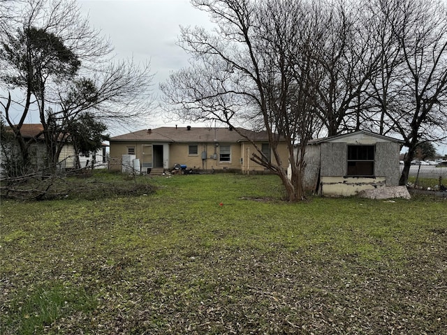 exterior space with a lawn and a storage shed