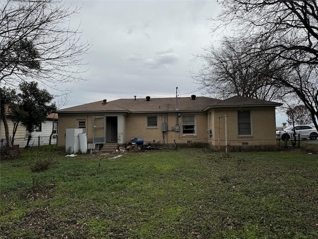 rear view of house with a yard