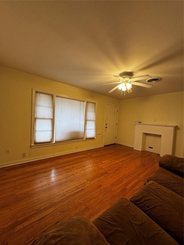 living room featuring ceiling fan and wood-type flooring