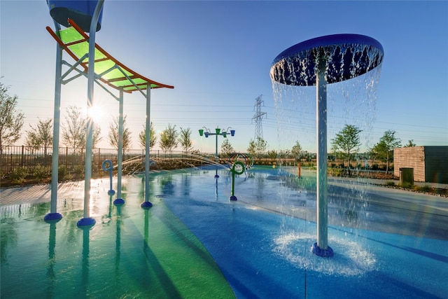 view of pool at dusk