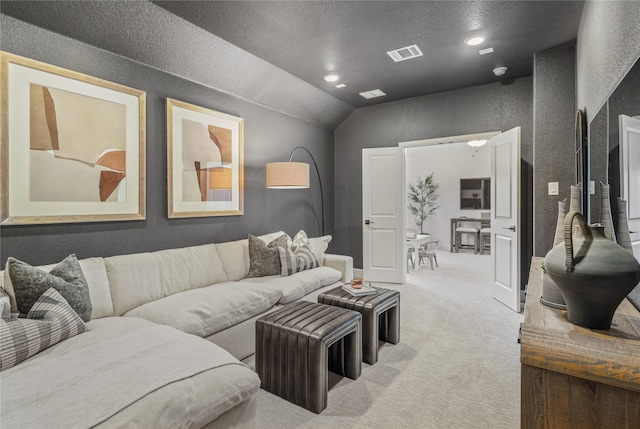 living room featuring lofted ceiling, carpet, and a textured ceiling