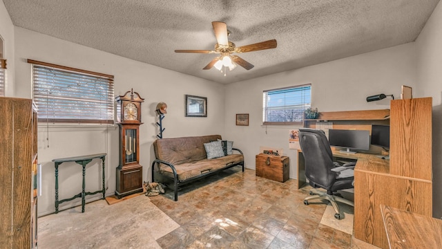 home office with ceiling fan and a textured ceiling