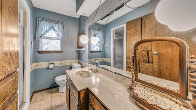 bathroom featuring toilet, tile patterned floors, an enclosed shower, and vanity