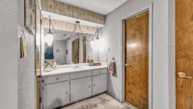 bathroom featuring a textured ceiling and vanity