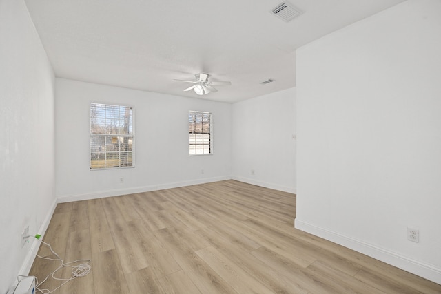 empty room featuring ceiling fan, light hardwood / wood-style floors, and a baseboard radiator