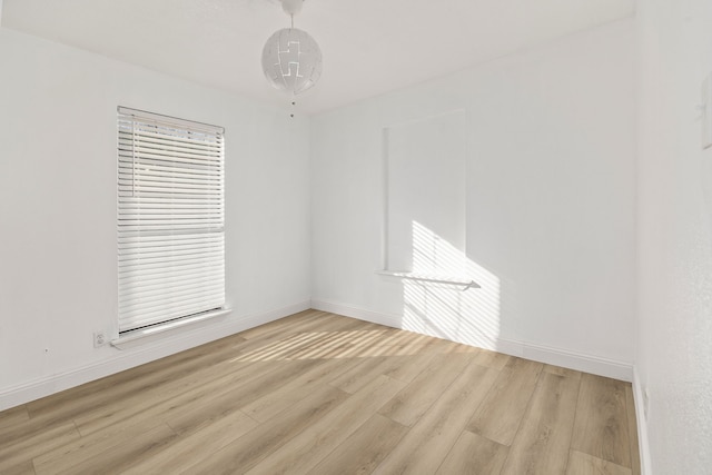 unfurnished room with light wood-type flooring