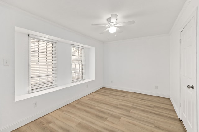 spare room featuring ceiling fan, ornamental molding, and light wood-type flooring