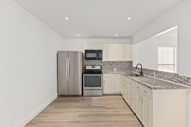 kitchen featuring tasteful backsplash, light hardwood / wood-style floors, sink, stainless steel appliances, and light stone counters