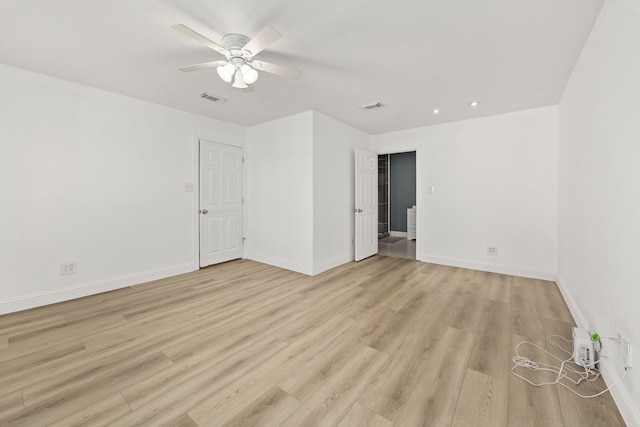 empty room featuring ceiling fan and light hardwood / wood-style floors