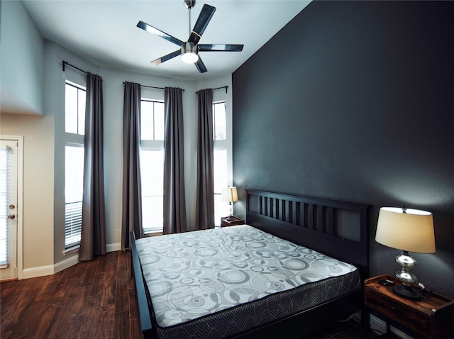 bedroom with dark wood-type flooring and ceiling fan