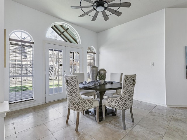 dining room with french doors, tile patterned floors, a wealth of natural light, and a ceiling fan