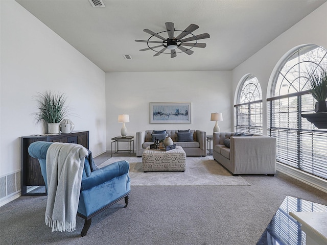 living room featuring ceiling fan, plenty of natural light, and carpet