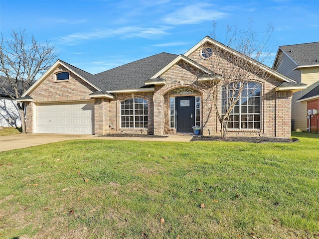 view of front of house featuring a garage, brick siding, concrete driveway, roof with shingles, and a front yard