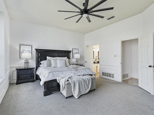 bedroom featuring carpet, visible vents, and a decorative wall