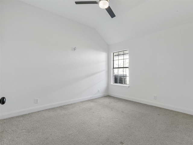 carpeted empty room with vaulted ceiling and ceiling fan