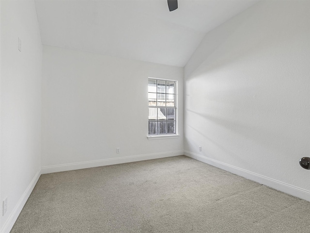 spare room featuring lofted ceiling and carpet floors