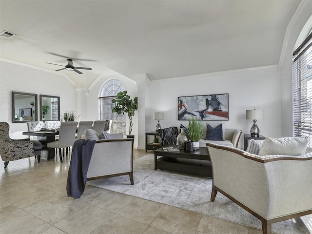 living room with light tile patterned floors, visible vents, vaulted ceiling, and ornamental molding