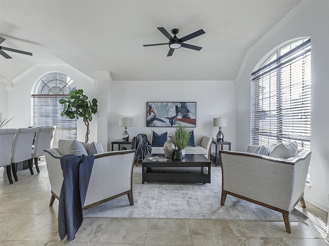 living room with ornamental molding, vaulted ceiling, and ceiling fan