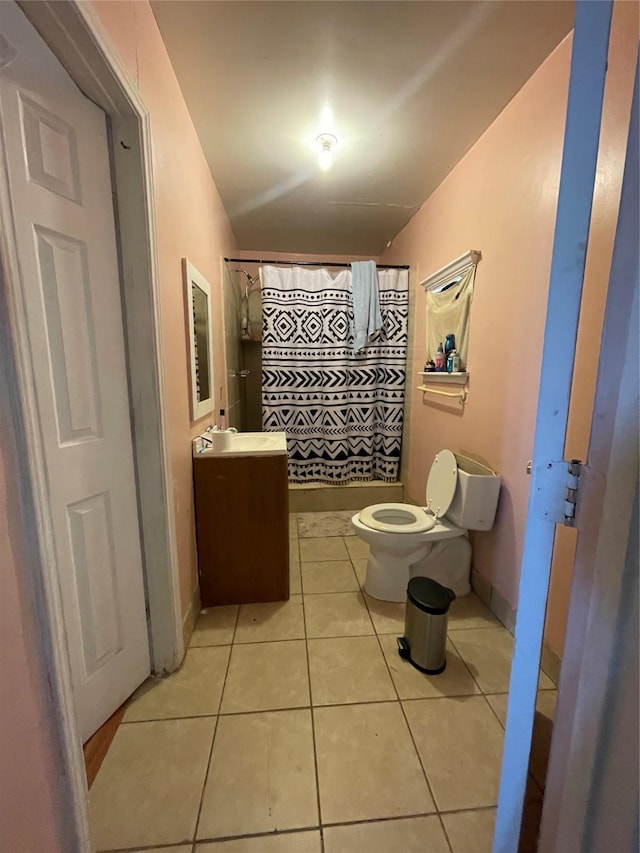 bathroom with curtained shower, tile patterned floors, vanity, and toilet