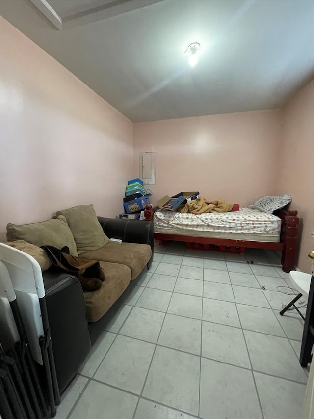 bedroom with light tile patterned flooring and electric panel