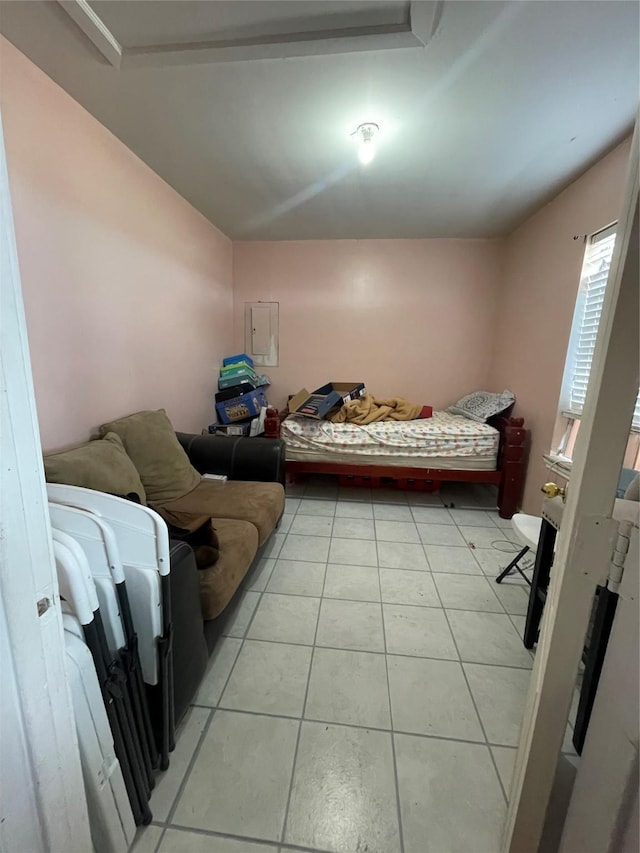 tiled bedroom with electric panel