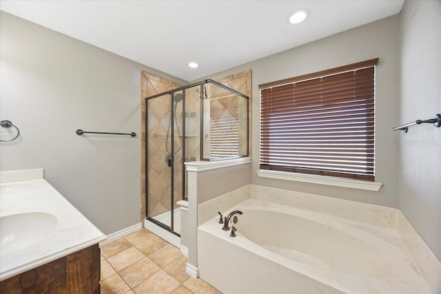 bathroom featuring vanity, a healthy amount of sunlight, independent shower and bath, and tile patterned flooring