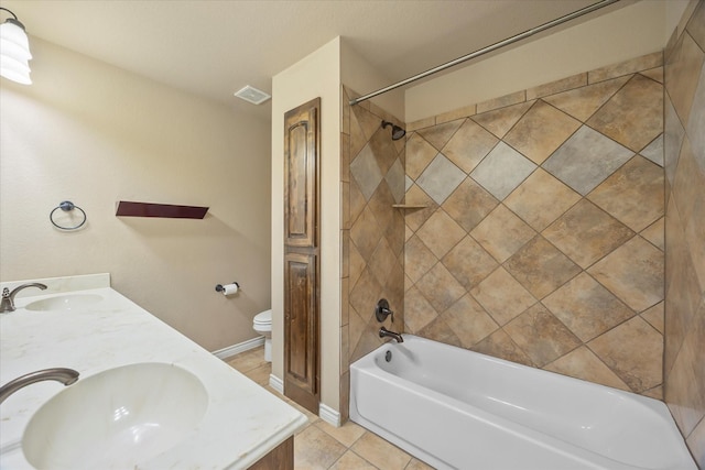 full bathroom with toilet, vanity, tile patterned flooring, and tiled shower / bath