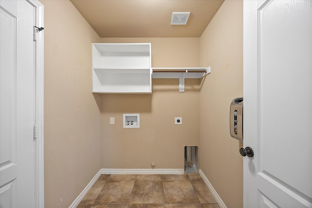 clothes washing area featuring washer hookup, a textured ceiling, gas dryer hookup, and electric dryer hookup