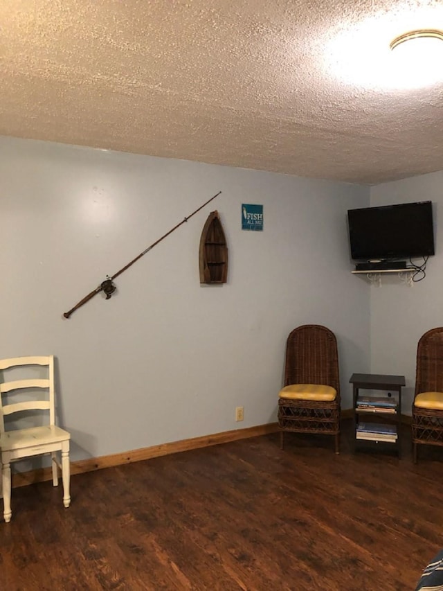 unfurnished room featuring a textured ceiling and dark hardwood / wood-style floors