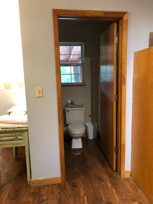 bathroom featuring hardwood / wood-style flooring and toilet