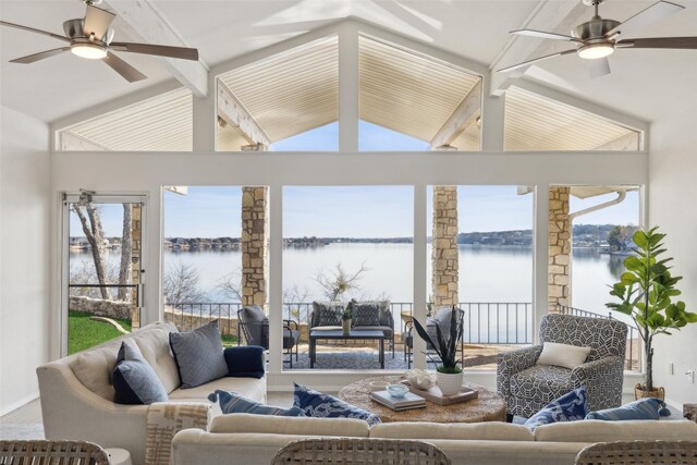 sunroom with a water view, ceiling fan, and lofted ceiling