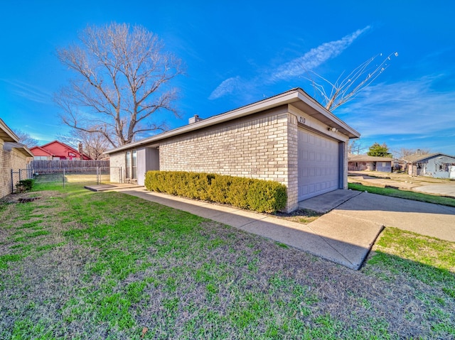 view of side of property featuring a garage and a lawn