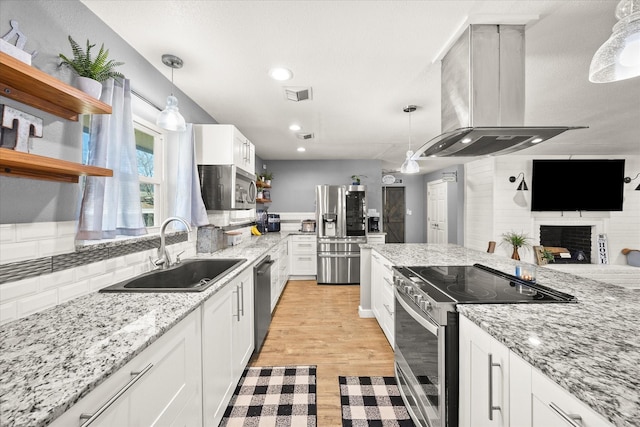 kitchen featuring backsplash, island exhaust hood, open shelves, a sink, and stainless steel appliances