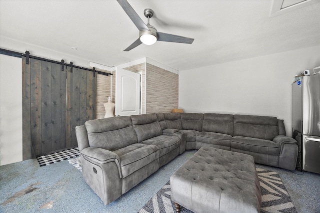 living room with ceiling fan and a barn door